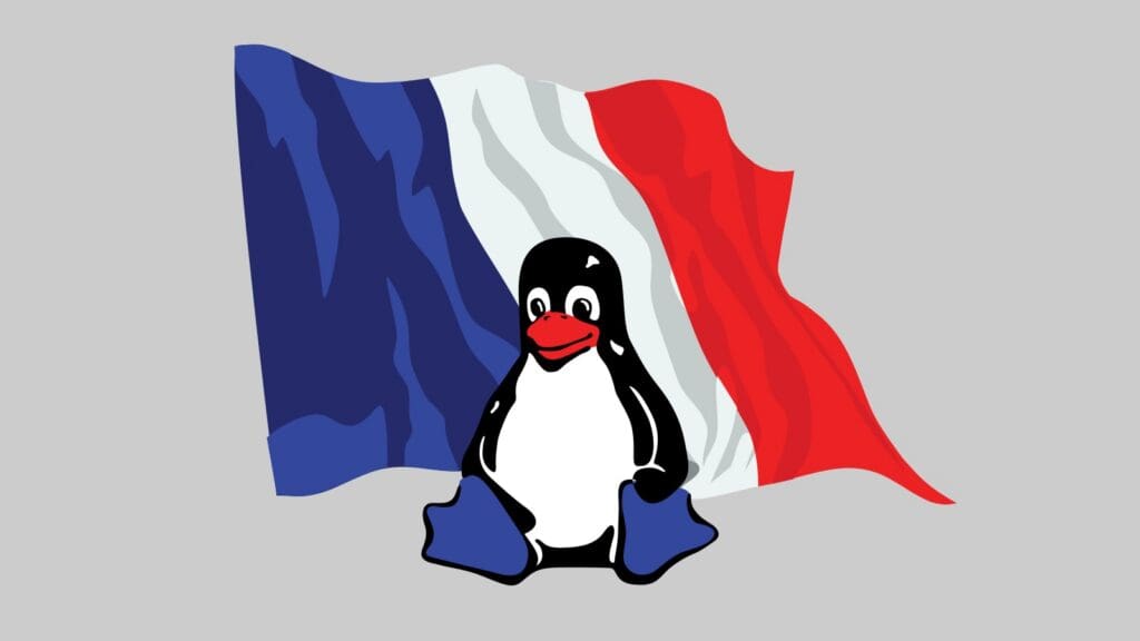 Tux, a mascota de Linux, diante da bandeira francesa ondeando, ilustrando a decisión do goberno de Francia de migrar os seus sistemas a Linux