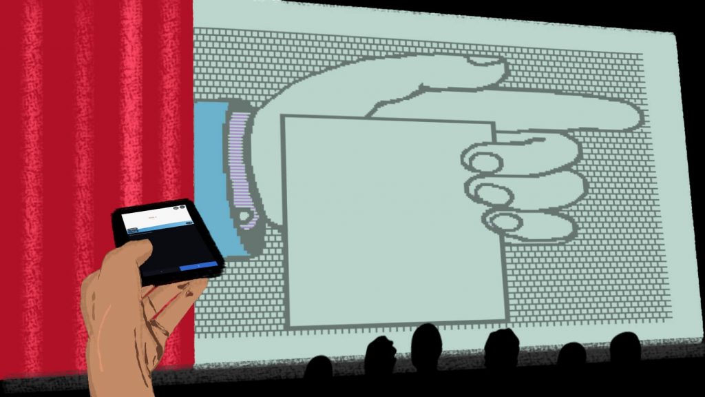 Unha man sostendo un teléfono preto apunta cara a unha gran pantalla que mostra a cara dun personaxe de historieta coas palabras "apontar" escritas nela. O fondo exhibe un telón vermello e unha parede gris.